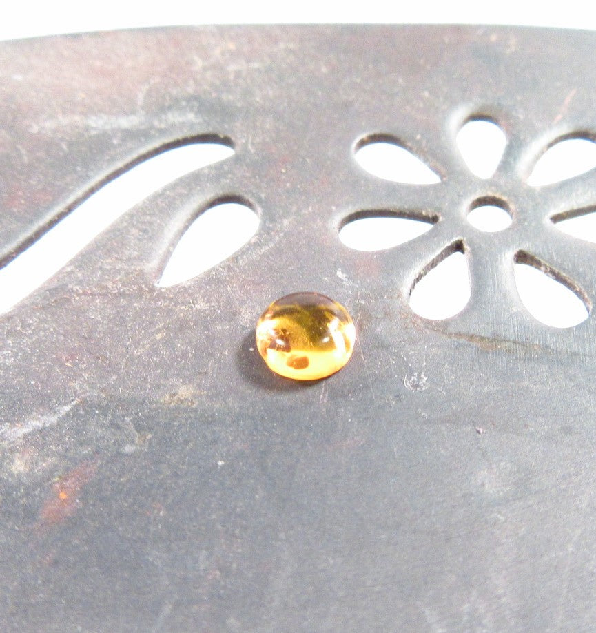 amber gemstone on dish